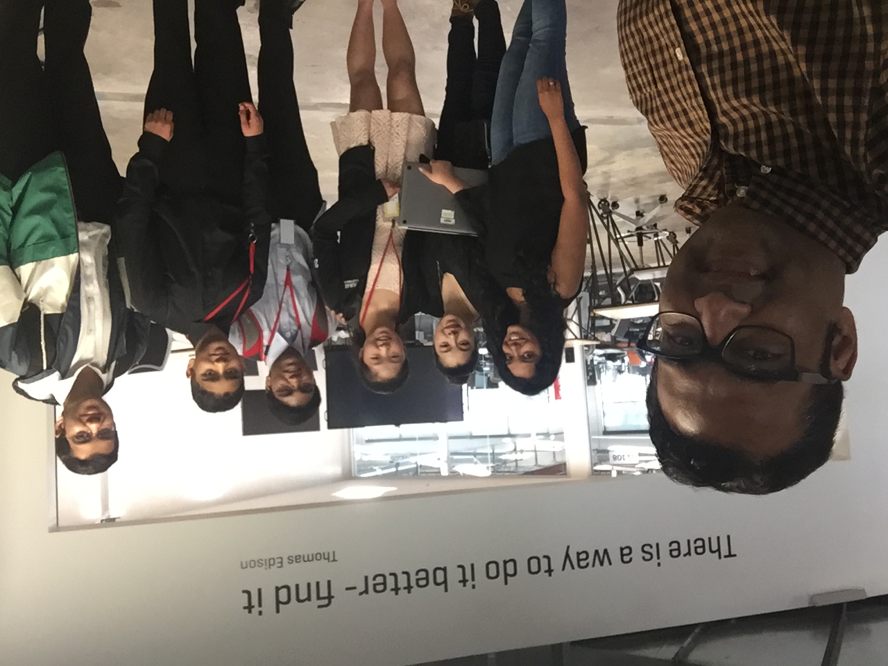 A man takes a selfie with a group of students at the end of their job shadow day.