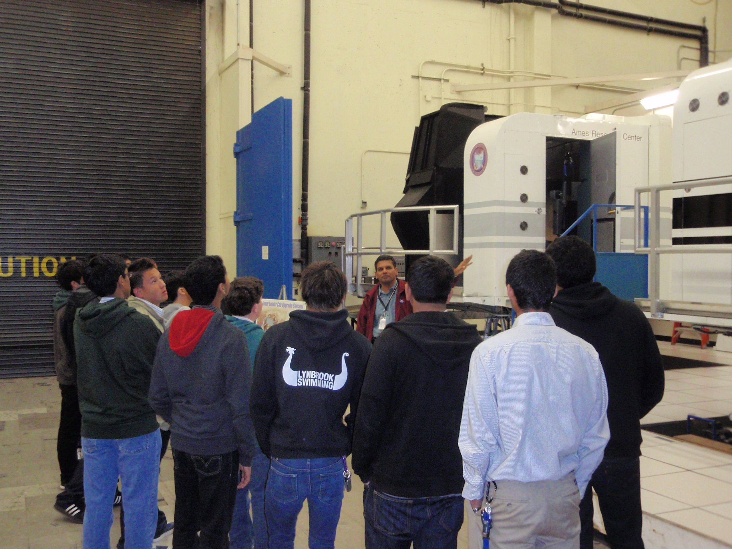 A group of students hearing somebody talk at the Ames Research Center for NASA.